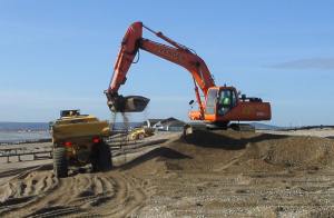 Digger loads dumptruck